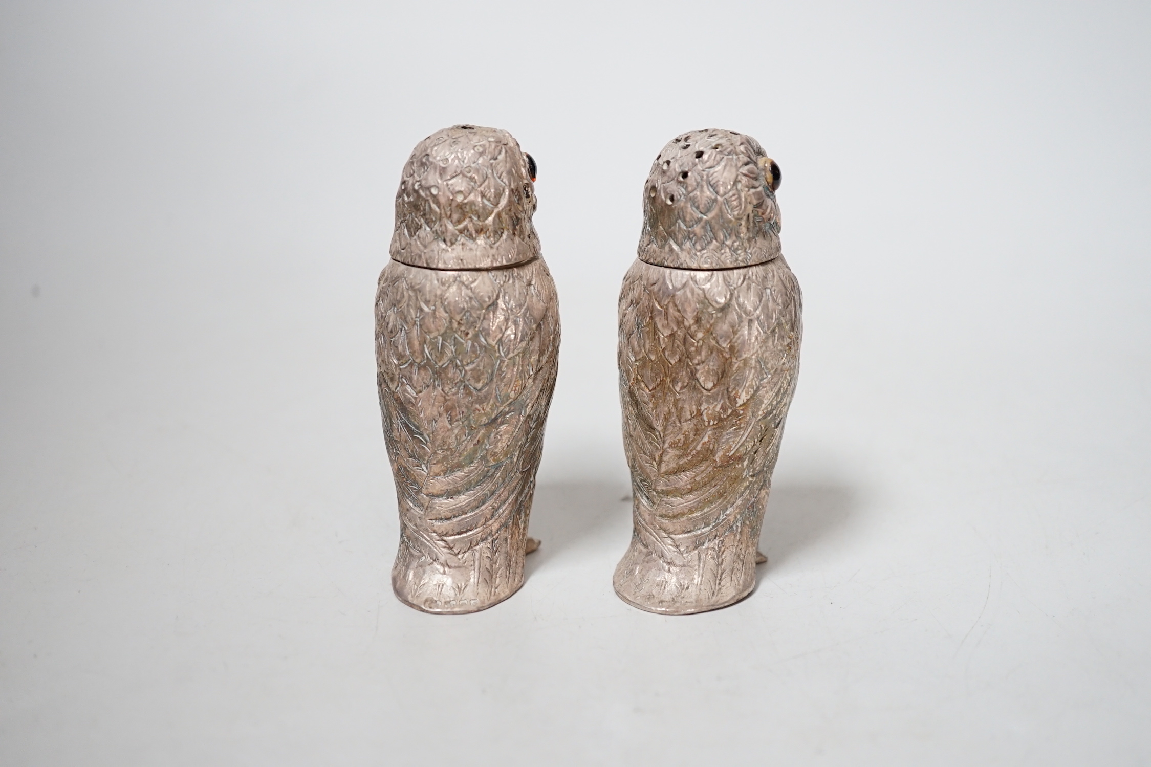 A pair of Queen Elizabeth II novelty silver owl pepperettes, makers DMS, London, 1972, 82mm.